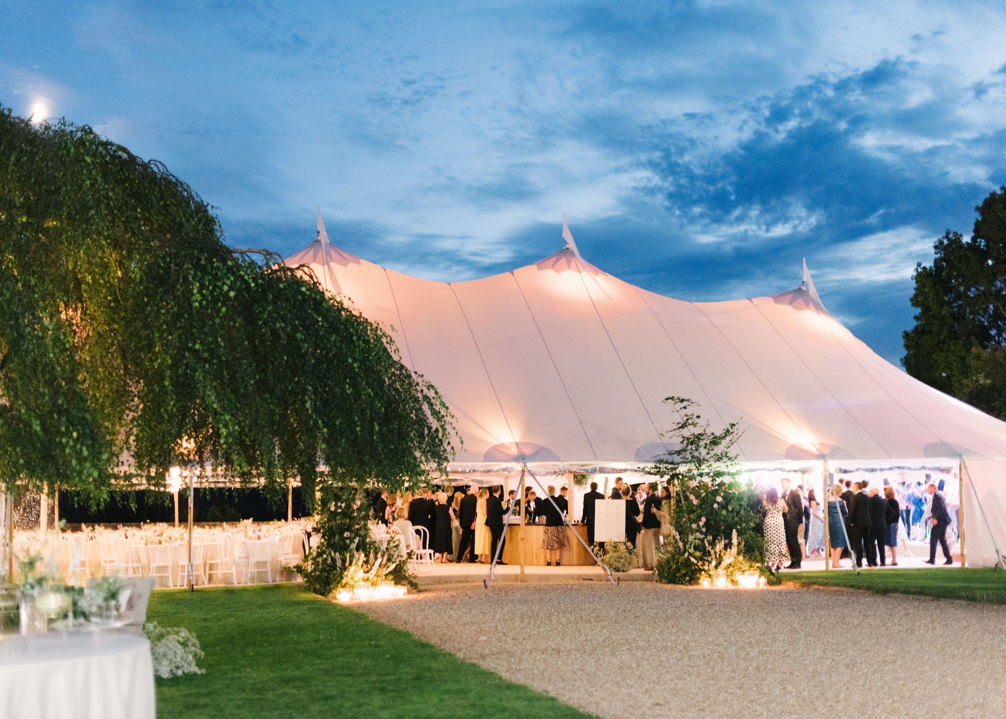 Sperry Tent Exterior at night, planned by Katrina Otter Weddings, with Aelisabet Flowers & The Sail Tent Company
