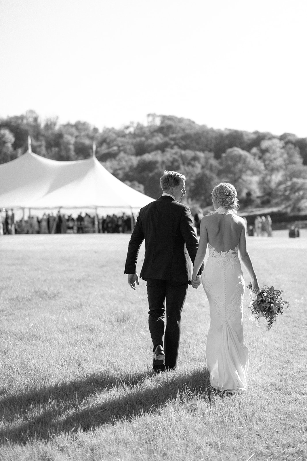 Suzie & Charlie approaching their Sperry Tent post ceremony